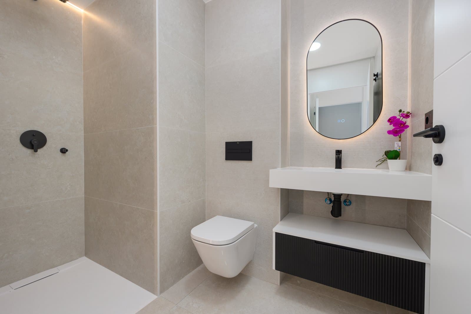 Show apartment bathroom with a flush-fitted shower