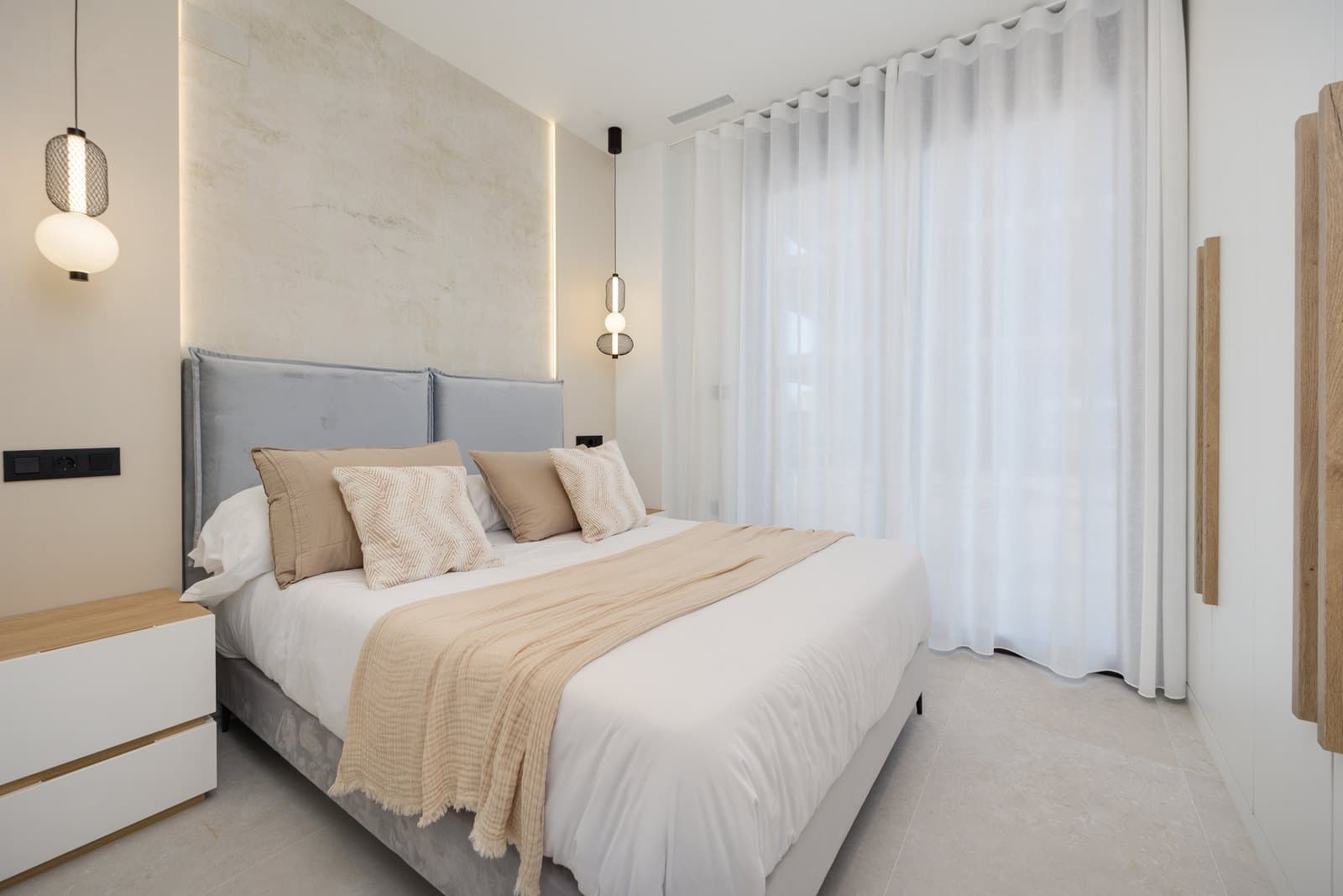 Show apartment bedroom with a glazed wall and curtains